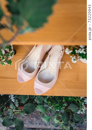 Women shoes, glamour beige high heel shoes on wooden background. Advertising women's shoes Women shoes, glamour beige high heel shoes on wooden background. Advertising women's shoes 73220943