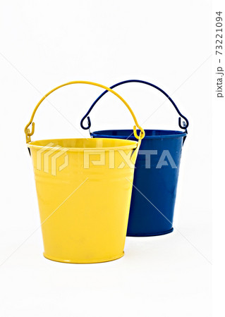 blue and yellow ornamental metal bucket isolated 73221094