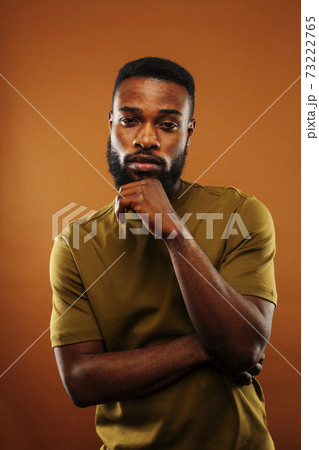 young pretty african american man posing cheerful on brown background, lifestyle people concept 73222765