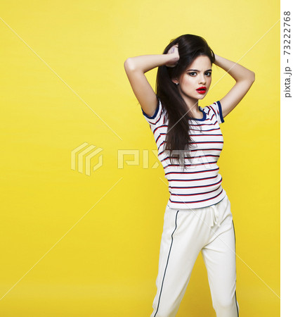lifestyle people concept: pretty young school teenage girl having fun happy smiling on yellow background 73222768