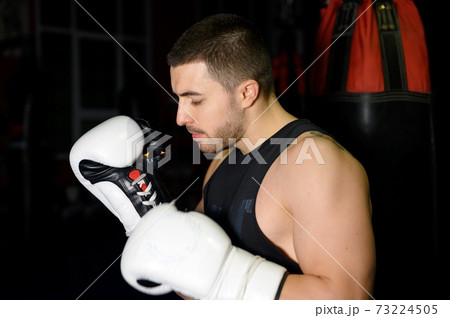 Confident boxer standing in pose and ready to fight. Confident boxer standing in pose and ready to fight. 73224505