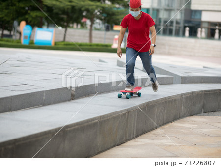 Skateboarder skateboarding in modern city Skateboarder skateboarding in modern city 73226807