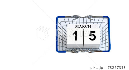 wooden calendar with date 15 march and shopping basket on white background. supermarket basket. World Consumer Rights Day wooden calendar with date 15 march and shopping basket on white background. supermarket basket. World Consumer Rights Day 73227353