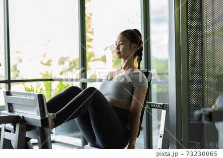 Happy Asian Sporty young woman in sportswear workout and exercise with leg machine at modern gym,Sport and Recreation Concept Happy Asian Sporty young woman in sportswear workout and exercise with leg machine at modern gym,Sport and Recreation Concept 73230065