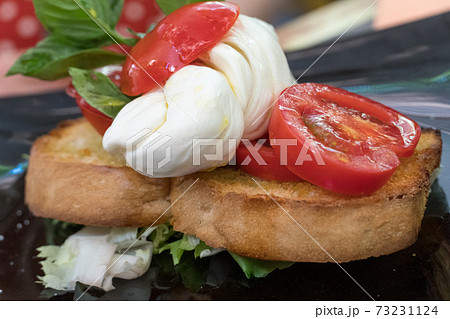 Tomato, mozzarella and basil bruschetta, Italian recipe. Selective focus 73231124