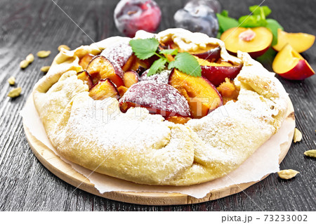 Galeta with plums on wooden board Galeta with plums on wooden board 73233002