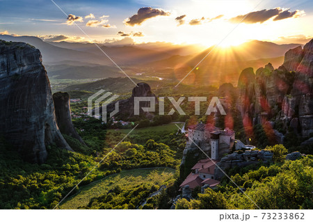Iconic view of Meteora valley at sunset, mountains, rocks, Moni Agias Varvaras Roussanou nunnery, natural lens flare, Greece, UNESCO World Heritage Iconic view of Meteora valley at sunset, mountains, rocks, Moni Agias Varvaras Roussanou nunnery, natural lens flare, Greece, UNESCO World Heritage 73233862