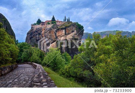Close view of clifftop Eastern Orthodox monastery of Holy Trinity or Agia Triada in famous Meteora valley, Greece, UNESCO World Heritage, cloudy sky 73233900