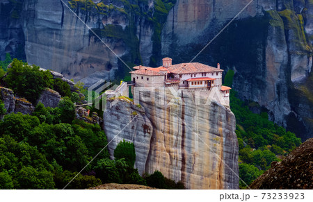 Close view of Moni Agias Varvaras Roussanou nunnery and spectacular massive rocky pillars of Meteora, Thessaly, Greece and rich foliage. 73233923