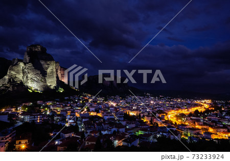 Night view of Kalambaka and Kastraki village at foot of high cliffs and rocks of Meteora valley. Greece, UNESCO World Heritage Night view of Kalambaka and Kastraki village at foot of high cliffs and rocks of Meteora valley. Greece, UNESCO World Heritage 73233924