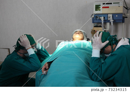 patient die in performing operation in hospital, Team of surgeons so sad and mourning patient die in performing operation in hospital, Team of surgeons so sad and mourning 73234315