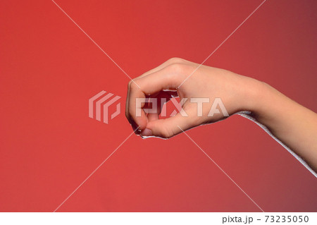 Human hand, folded together to take a little small, isolated on a red background Human hand, folded together to take a little small, isolated on a red background 73235050