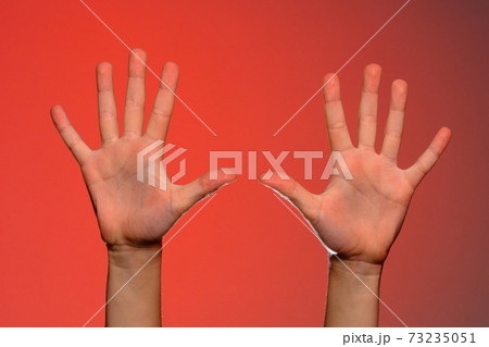 The human hand shows five fingers, which symbolizes affection. Isolated on a red background The human hand shows five fingers, which symbolizes affection. Isolated on a red background 73235051