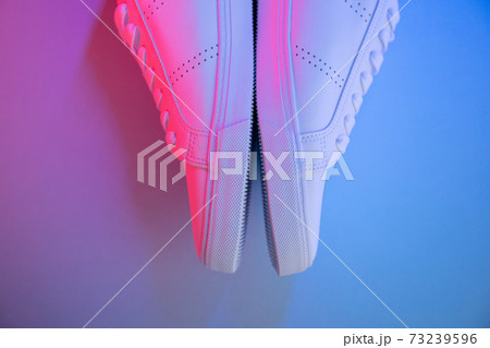 Pair of sneakers on color background, top view Pair of sneakers on color background, top view 73239596