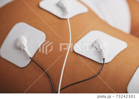 Myostimulation electrodes on the buttocks and legs of a woman in a beauty salon. 73242301