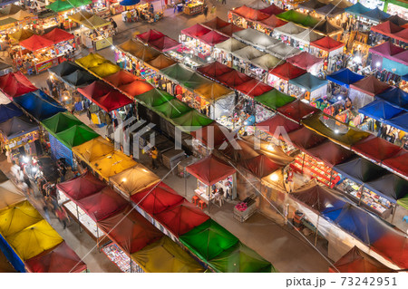Aerial top view of Night Market people walking street, Colorful tents in the train of Ratchada at Bangkok city, Thailand. Rerail shops Aerial top view of Night Market people walking street, Colorful tents in the train of Ratchada at Bangkok city, Thailand. Rerail shops 73242951