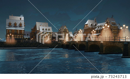 Riverfront of cozy medieval town at winter night 73243713
