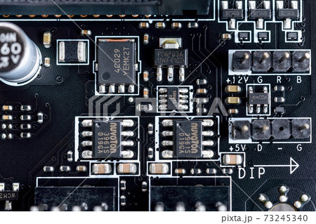 Electronic circuit board with microchips and other components on a modern black motherboard.  Electronic circuit board with microchips and other components on a modern black motherboard.  73245340