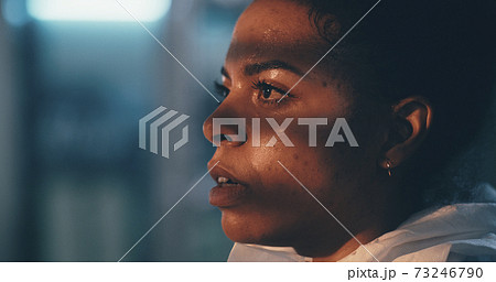Sweaty black woman taking of hazmat suit 73246790