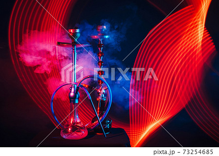 smoky Turkish hookahs with coals on bowls and water in flasks 73254685