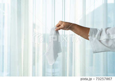 Senior women hand holding napkin/tissue paper Senior women hand holding napkin/tissue paper 73257867