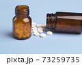 Medicine white pills and glass pills of bottles 73259735