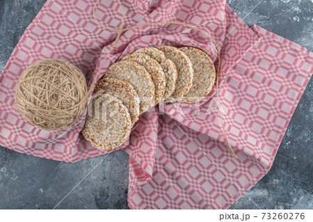 Rice waffles with a ball of yarn on a tablecloth Rice waffles with a ball of yarn on a tablecloth 73260276