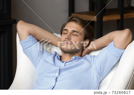 Young man relax in chair sleeping at home Young man relax in chair sleeping at home 73260817