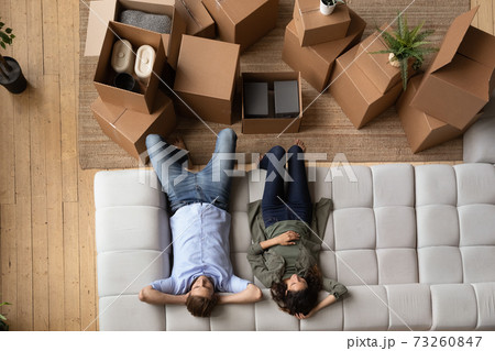 Top view of couple relax on sofa on moving day Top view of couple relax on sofa on moving day 73260847