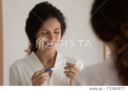 Happy woman excited about positive pregnancy test result Happy woman excited about positive pregnancy test result 73260977