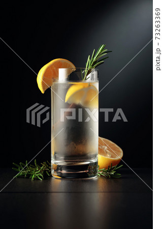 Cold refreshing drink with ice, lemon, and rosemary. 73263369