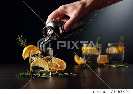 Cocktail Gin and Tonic with lemon and rosemary. 73263370
