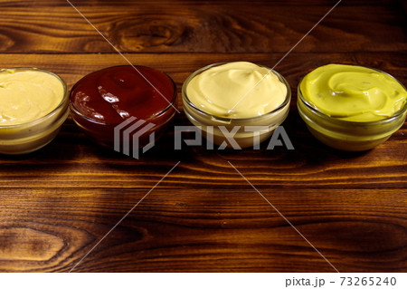 Set of sauces on wooden table Set of sauces on wooden table 73265240