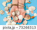 Woman holding shells in her hands 73266313