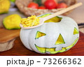 Carved Halloween pumpkin head on table 73266362