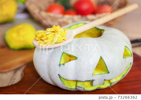 Carved Halloween pumpkin head on table 73266362