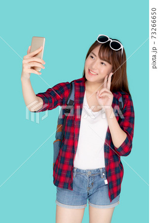 Beautiful portrait young asian woman cheerful smiling and take selfie on smart mobile phone. 73266650