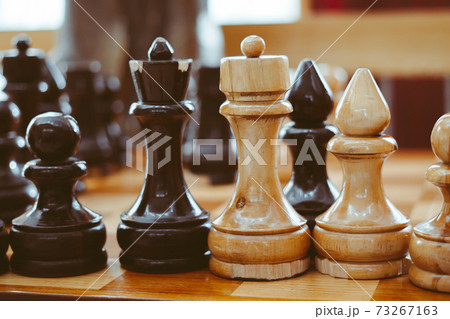 hand holding a chess piece over the Board hand holding a chess piece over the Board 73267163