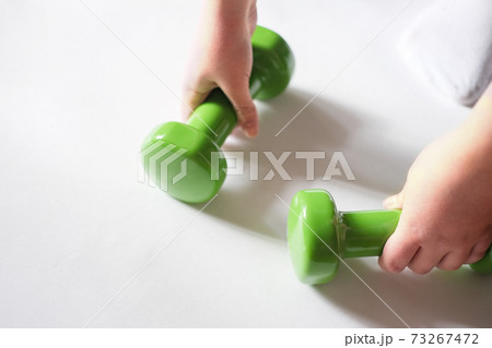 teenage girl hand holding dumbbels. Healthy lifestyle, sport concept. Close up view 73267472
