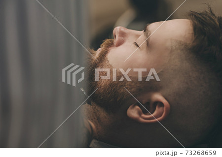 professional barber cuts a man's beard i professional barber cuts a man's beard i 73268659