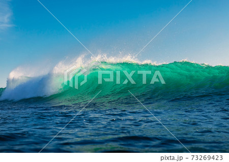 Surfing wave in ocean. Breaking turquoise wave sunny day Surfing wave in ocean. Breaking turquoise wave sunny day 73269423