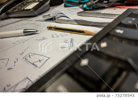 Workplace in the office with scrawled white paper Workplace in the office with scrawled white paper 73270543