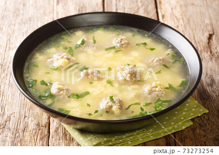 Sciusceddu is a festive Italian soup with the lightest, most tender meatballs in a comforting creamy egg soup closeup in the plate. horizontal Sciusceddu is a festive Italian soup with the lightest, most tender meatballs in a comforting creamy egg soup closeup in the plate. horizontal 73273254