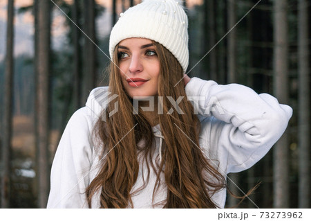Beautiful Young Woman in Winter Woods. Warm White Stylish Clothing 73273962