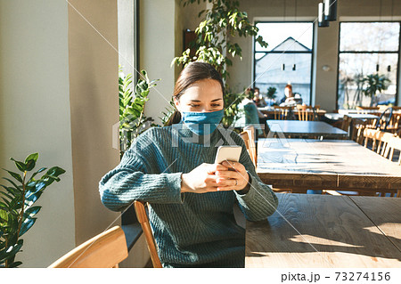 A girl uses a cell phone A girl uses a cell phone 73274156