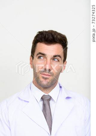 Face of handsome Hispanic man doctor thinking Face of handsome Hispanic man doctor thinking 73274325