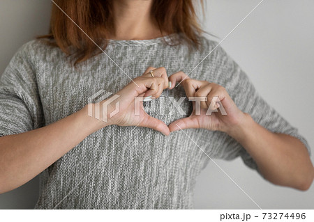 Close up of woman show love hand gesture Close up of woman show love hand gesture 73274496