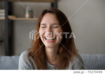 Close up of happy young woman laugh at home 73274499