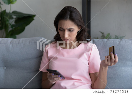 Unhappy woman frustrated by error paying online on cell Unhappy woman frustrated by error paying online on cell 73274513
