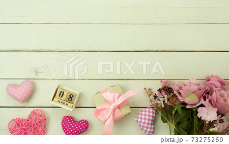Table top view aerial image of decorations for international women's day holiday concept background.Flat lay sign of season the word 8 march happy woman's day with heart shape on white wooden. Table top view aerial image of decorations for international women's day holiday concept background.Flat lay sign of season the word 8 march happy woman's day with heart shape on white wooden. 73275260